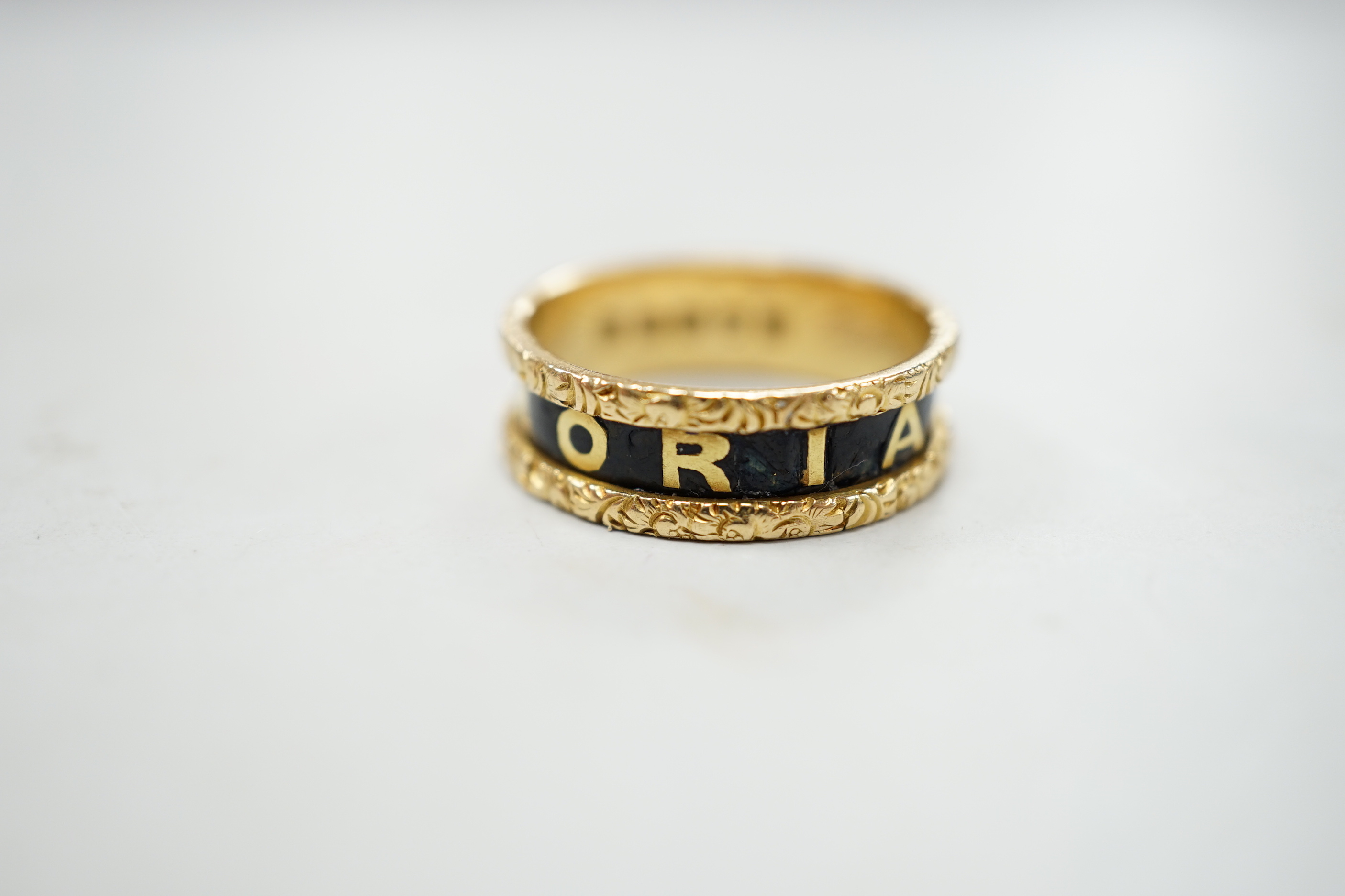 A Victorian 18ct gold and black enamel 'In Memoriam' band, inscribed ' Edwr John Lewis obt 5th April 1876, at 54', size N, gross weight 4 grams.